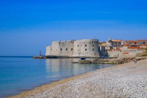 a large castle sitting on the shore of a body of water at La Vita e Bella IV in Dubrovnik