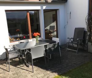 a table with a vase of flowers on a patio at Alpen-fewo, Denter Vias 10, Casa Alma in Flims