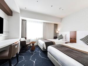 Ένα ή περισσότερα κρεβάτια σε δωμάτιο στο HOTEL MYSTAYS Sapporo Station