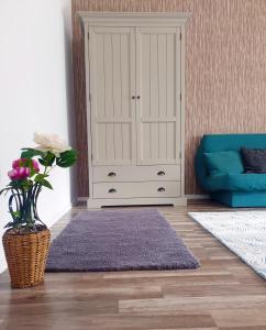 a living room with a cabinet and a purple rug at Happy Holiday Apartments in Predeal