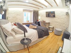a bedroom with a large bed and a desk at La Vita e Bella IV in Dubrovnik