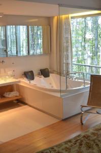 a large bath tub in a room with a window at CasaCalma Hotel in Buenos Aires
