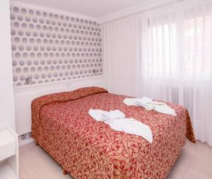 
a hotel room with a bed and a window at Estocolmo Hotel by bund in Mar del Plata
