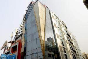 a tall glass building with a lot of windows at HOTEL SHREESH KOLKATA in Kolkata