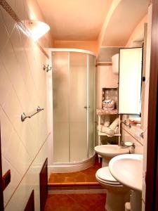 a bathroom with a shower and a toilet and a sink at Casa vacanze Mimí in Cefalù +58 photos