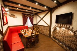 a dining room with red chairs and a fireplace at Green Park in Domodedovo