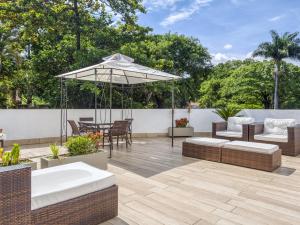 a patio with a table and an umbrella at Pampulha Design Hotel in Belo Horizonte