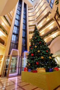 a christmas tree in the lobby of a building at Pur-Navolok Hotel in Arkhangelsk