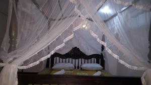 a bedroom with a bed with a canopy at Samudra Guest House in Mirissa