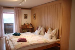 a bedroom with a bed with pillows on it at Haus Mauken - Appartments mit Panoramablick in Murau