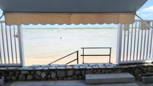 a view of the beach from a pavilion with a bench at Suites Enseada Beira Mar in Coruripe