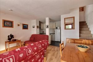 a living room with a couch and a table at DUPLEX AVEC ACCES PISCINE - SAINT JEAN D'AULPS STATION - 9 PERSONNES - DAILLE D10 in Saint-Jean-dʼAulps