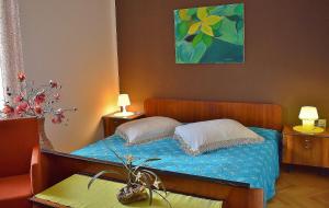a bedroom with a bed with two pillows on it at Apartman Balen J. in Banjol