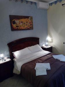 En eller flere senge i et værelse på VILLETTA SCALA DEI TURCHI a SOLI 40 MT DAL MARE