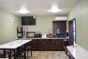 a room with a kitchen with aasteryasteryasteryasteryasteryasteryasteryasteryastery at Super 8 Downtown Raleigh in Raleigh