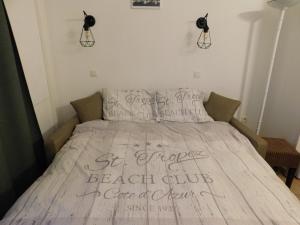 a bedroom with a bed with writing on it at Les Restanques - Grimaud in Grimaud +35 photos