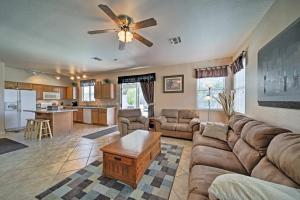 a living room with a couch and a table at Goodyear Home with Pool, 2 Mi to Goodyear Ballpark in Goodyear