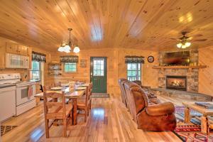 a dining room with a table and a fireplace at Rustic Benezette Cabin with Porch, Hot Tub and Fire Pit in Benezette