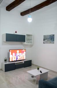a living room with a large flat screen tv at AL TEATRO VERDI LUXURY APARTMENT in Salerno