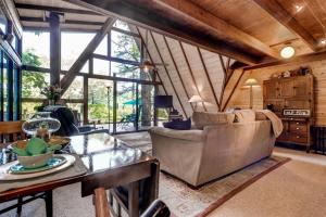 a living room with a couch and a table at Dock and Resort Perks Quiet Lakefront Cottage in Innsbrook