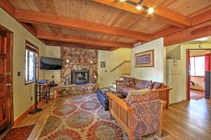 a living room with a couch and a fireplace at Big Bear Cabin with Fenced Yard 4 Mi to Snow Summit in Big Bear City