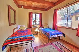 a bedroom with two beds and a window at Big Bear Cabin with Fenced Yard 4 Mi to Snow Summit in Big Bear City