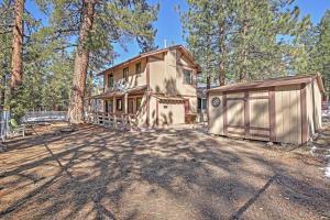 a house in the woods with a garage at Big Bear Cabin with Fenced Yard 4 Mi to Snow Summit in Big Bear City