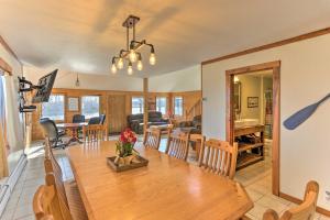 a dining room and living room with a table and chairs at Waterfront Indian Lake House Deck and Private Dock! in Lakeview