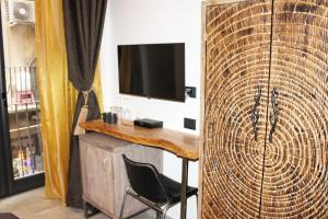 a room with a desk and a tv on a wall at B&B Quispaccanapoli in Naples