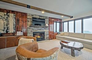 a living room with a couch and a fireplace at Updated Beech Mountain Condo with Views, Near Skiing in Beech Mountain