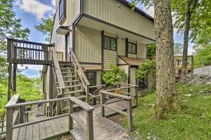a home with a wooden staircase leading up to a house at All-Season Base w/ Views in Beech Mountain! in Beech Mountain