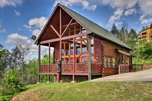 a log cabin with a large deck on a hill at Expansive Gatlinburg Cabin Hot Tub, Deck and Grill! in Gatlinburg