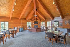 a large room with wooden ceilings and tables and chairs at Silverthorne Condo Patio, Mtn Views, Pool Access! in Silverthorne