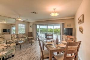 a living room with a table and a couch at Waterfront Marco Island Retreat with Shared Docks in Marco Island