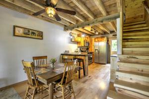 a kitchen with a table and chairs and a ceiling fan at Lovely Ulster Cabin with Hot Tub, Fire Pit and 3 Ponds in Ulster