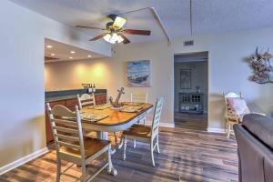 a dining room with a table and chairs and a ceiling fan at Chic Myrtle Beach Seaside Escape with Pool Access! in Myrtle Beach