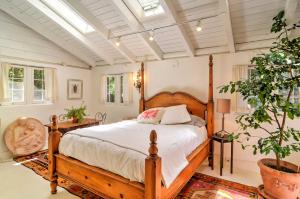 a bedroom with a wooden bed in a room at Charming Santa Fe Studio Cabin with Patio and Yard! in Santa Fe
