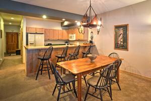 a kitchen and dining room with a wooden table and chairs at Mountain Condo Half Mi to Breckenridge Ski Slopes in Breckenridge