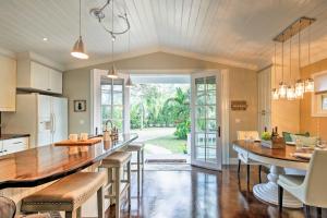 a kitchen with a large island with bar stools at Chic Sarasota Cottage Near Beaches and Downtown! in Sarasota