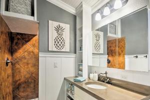 a bathroom with a sink and a mirror at Chic Sarasota Cottage Near Beaches and Downtown! in Sarasota +17 photos