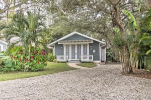 a small blue house with a gravel driveway at Chic Sarasota Cottage Near Beaches and Downtown! in Sarasota
