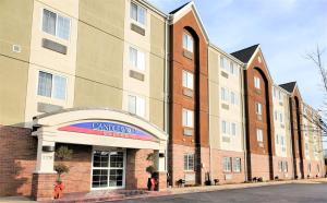 a building with a canadianknife sign in front of it at Candlewood Suites Fayetteville, an IHG Hotel in Fayetteville