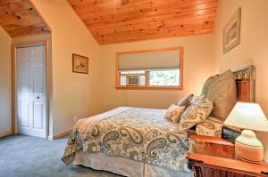 a bedroom with a bed and a table with a lamp at Waterfront Prospect Harbor Cottage Yard, Fire Pit in Prospect Harbor