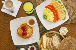 a table with plates of breakfast foods and a cup of coffee at Hotel Retiro 84 in Bogotá +33 photos