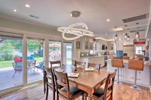 a kitchen and dining room with a table and chairs at Parma Heights Home with Private Yard and Pergola in Parma Heights