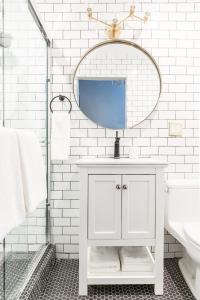 a white bathroom with a sink and a mirror at Sonder Hayes Valley in San Francisco