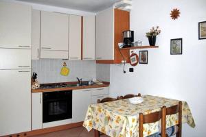 a kitchen with a table and a kitchen with white cabinets at CASA DELLA VALLE in Colico +27 photos