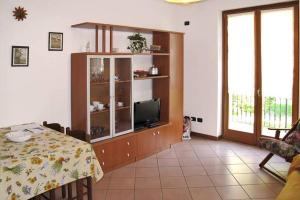 a living room with a entertainment center with a television at CASA DELLA VALLE in Colico
