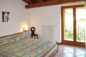 a bedroom with a bed and a sliding glass door at CASA DELLA VALLE in Colico