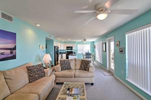 a living room with two couches and a ceiling fan at Beachfront Cedar Key Condo with Pool, Spa and Views! in Cedar Key